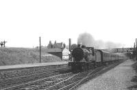 Corkerhill 2P 4-4-0 no 40595 westbound through Ibrox station in July 1955 with a St Enoch - Largs train. The signals on the extreme left of the picture are on the Govan branch (closed to all traffic in 1966). [See image 60005].<br><br>[G H Robin collection by courtesy of the Mitchell Library, Glasgow 27/07/1955]