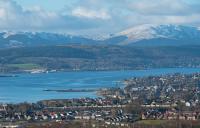 A 66 with the empties from the Lochaber Smelter drops down from Helensburgh Upper to Craigendoran. This view overlooking Helensburgh and the Gare Loch is from the east taken from close to the 'Railway Glen'. Rosneath Shipyard is in the background. The east fanlight of Helensburgh Central also features in this view, can you spot it?<br><br>[Ewan Crawford 02/02/2018]