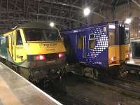 Contrast of curves  and right angles at Glasgow Central as 90049 (on the Lowland Sleeper ECS), and 314203 (soon to leave for Paisley Canal) wait at platforms 10 and 11 respectively. 7th February 2018.<br><br>[Colin McDonald 07/02/2018]