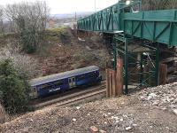 The 1007 to Dalmuir passes under the temporary pedestrian bridge on its approach to Baillieston on 22nd February 2018. The Muirhead Road overbridge which is being replaced had been reduced  to a single carriageway with a weight restriction some years before.<br><br>[Colin McDonald 22/02/2018]
