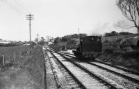 A view from the platform at Herston Halt towards Swanage as 0-6-0ST loco 'Cunarder' runs round the train in May 1984.<br><br>[John McIntyre /05/1984]