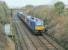 68029 hauls three DRS coaches and 68003 under the Ironworks Tramroad bridge at Warton on 12th January 2018. This was a driver training run from Carlisle to Carnforth and back, ahead of the anticipated replacement of the Class 37/4 & DBSO formations on Cumbrian Coast services with top and tail Class 68s.<br><br>[Mark Bartlett 12/01/2018]