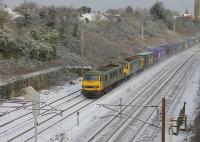 Freightliner 90041 and 90043 raise flurries of fresh snow as they take a southbound intermodal through Farington Curve Junction on 27th February 2018.  <br><br>[Mark Bartlett 27/02/2018]