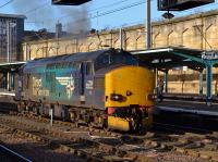 DRS 37218 opens up after a signal check, on its way from Kingmoor to Crewe, one of three Class 37s seen in the station in a 30 minute period on 21st February 2018.<br>
<br>
<br><br>[Bill Roberton 21/02/2018]