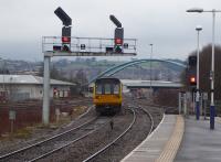 Pacer 142041 leaves Blackburn with a Colne to Preston stopping service on 14th February 2018. This is probably the unit's last full year of operational service. The signals control the junction with the Bolton line, which diverges near the large road bridge.  <br><br>[Mark Bartlett 14/02/2018]
