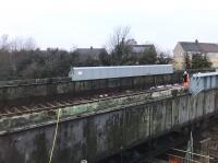 Double take time - what at first glance might appear to be railway track across the Muirhead Road overbridge is in fact the corrugated metal of the deck, now exposed on the southern part of the bridge, with a pipe pretending to be a length of rail. <br><br>[Colin McDonald 05/03/2018]