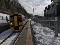 158708, forming the 1103 for Edinburgh, pulls into the part cleared platform at Galashiels on a bright 7th March 2018. As we travelled north the fields and embankments were still well covered with snow all along the route. <br>
<br>
<br><br>[Bruce McCartney 07/03/2018]