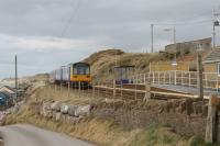 The tiny station at Braystones is in a remote but spectacular location on the Cumbrian Coast. Note the <I>Harrington Hump</I> and two sets of portable steps on the single platform as a southbound service hurries through on 8th March 2018. <br><br>[Mark Bartlett 08/03/2018]