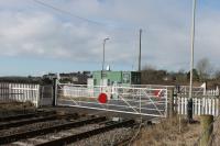Kirksanton, one of two level crossings just north of Millom, is manually operated by a gatekeeper based in the green hut who also controls protecting semaphore signals. There was a station here very briefly but it closed in 1857.  <br><br>[Mark Bartlett 09/03/2018]