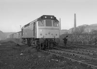 A BR Class 25 arrives at the Cutler Sidings, Waterside, with empty wagons on 20th December 1977.<br>
<br>
<br><br>[Bill Roberton 20/12/1977]