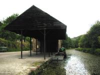 The transit shed alongside the Cromford Canal at High Peak Junction in the summer of 2002, looking north towards Matlock.<br><br>[Ian Dinmore 22/06/2002]