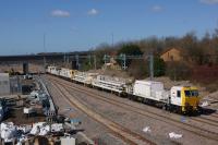 A Network Rail engineering train made up of MPVs and trailers proceeds slowly over Kirkham North Jct as it approaches the engineering possession on the Blackpool North line on 19 March 2018. The train appears to be involved in the electrification of the line and had originated at Crewe.<br><br>[John McIntyre 19/03/2018]