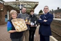 Dumfries station will be transformed into a farmers' market in the coming weeks.  Local producers will be given space under the canopy in the station car park when the Dumfries Farmers' Market relocates from Lockerbie Road on Sunday, 1 April 2018.<br>
<br>
The market will be held under the canopy where, until 1965, trains left for Stranraer and Kirkcudbright.<br>
<br>
The monthly event is the largest local food market in the south of Scotland, and up to 30 producers will be setting up their stalls under the Victorian pavilion next to the station building.<br>
<br>
On sale will be a wide variety of locally-produced food and drink, including locally reared meats, pies, soups, baked goods, and locally produced drinks.<br>
<br>
Left to Right - Chair of Dumfries Farmers Market Sarah Burchell, Max Nowell of Steilhead Cider, Carol Johnston of John Watt & Son Coffee, ScotRail Alliance Station Team Manager George Cameron.<br><br>[ScotRail //2018]