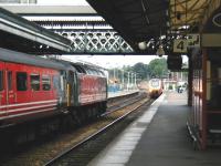 47741 <I>Resilient</I> standing alongside platform 5 at Exeter St Davids on 4 June 2002 with a Virgin CrossCountry service, while in the background a westbound Voyager is running into platform 4. <br><br>[Ian Dinmore 04/06/2002]