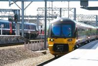 Soaking up the sunshine at Leeds on 22 April 2009. On the right Northern 333005 is arriving with the 1300 ex Bradford Forster Square. Over to the left is the recently terminated East Coast Trains 1105 from London Kings Cross.  <br><br>[John Furnevel 22/04/2009]