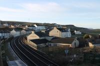 Early morning at Harrington on 9th March 2018 with the rising sun illuminating the scene. This view looks south from the station footbridge along the line towards Parton and Whitehaven and should have included a Cass 37 hauled passenger train but that had failed at Sellafield. <br><br>[Mark Bartlett 09/03/2018]