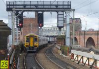 158754, on a Manchester Oxford Road to Selby service, passes Castlefield Junction on 27th March 2018 heading for the new Ordsall Chord link to Manchester Victoria and the Calder Valley route. This view looks west from the platform at Deansgate. The CLC route diverges left at this point and on the right of the picture the old Midland lines, now Metrolink, climb to cross the Network Rail tracks. <br><br>[Mark Bartlett 27/03/2018]