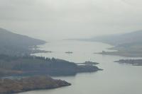 Calmac <I>MV Loch Dunvegan</I> is mid way across the narrow eastern Kyle of Bute on a misty morning in April 2018. This image, taken from the viewpoint on the A8003 Tighnabruaich road, shows the point where Loch Riddon meets the Kyles at the northern tip of Bute. <br><br>[Mark Bartlett 07/04/2018]