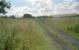 View north from the trackbed of the former Waverley Route at Falahill Summit in 2002. The trackbed was used as an access road for the former railway cottage after closure of the line. The roof of the cottage can be seen on the distant right. The signal box and water tank were to the right and down sidings to the left.<br><br>[Ewan Crawford //2002]