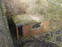 Over thirty years of vegetation growth has completely covered most of the actual Corkickle Brake incline but right at the foot this small building survives next to the Meadow View road bridge. Presumably this was where the men connecting and disconnecting the wagons to the cable were based. Beyond here the tracks fanned out into the exchange sidings, again now heavily overgrown, where a BR shunter sorted the incoming and outgoing wagons. 13th March 2018.  <br><br>[Mark Bartlett 13/03/2018]