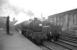 Black 5 45228 at the head of the 8.50am summer Saturday Blackpool Central - Glasgow Central at Carlisle platform 1 on 4 July 1964. The locomotive has just relieved Jubilee 45627 <I>Sierra Leone</I> which had brought the train north [See image 61283]. Standing alongside in the west sidings is Ivatt 4MT 2-6-0 43036. <br><br>[K A Gray 04/07/1964]