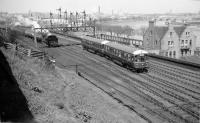 The BMU approaching Ferryhill Junction with the 14.45 Aberdeen to Ballater service (April 1958). The 'Aberdeen – Ballater' boards on the sides of both vehicles can be seen clearly in this view. The steam locomotive on the left is one of the Class N15 0-6-2T engines used for station pilot duties at the south end of Aberdeen station at the time.<br><br>[David Murray-Smith /04/1958]