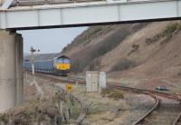 View from the north end of Sellafield station, looking past the signal box, on 8th March 2018. DRS 66301 is stabled at the head of a long rake of GBRf box wagons, with a classmate on the other end of the train. The siding, alongside the single track to St. Bees, is on the formation of the long closed line to Egremont.<br><br>[Mark Bartlett 08/03/2018]