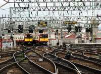 Local trains at Glasgow Central and railfan on right.<br><br>[Ewan Crawford //]