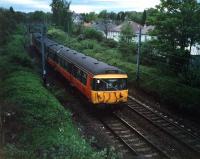 A 303 heads for Bearsden after leaving Hillfoot. This view has a lot to answer for; my grandfather used to hold me up here to see the new trains.<br><br>[Ewan Crawford //1987]