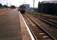 Westbound train at Dumbarton East. The loop track and line off to the right have been lifted.<br><br>[Ewan Crawford //1987]