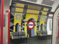 <h4><a href='/locations/M/Marble_Arch'>Marble Arch</a></h4><p><small><a href='/companies/C/Central_London_Railway'>Central London Railway</a></small></p><p>Gaudy murals at Marble Arch, seen from eastbound train of LUL 1992 stock waiting to depart with a Central Line service to Epping, on 18th January 2014. This station, situated in the heart of London's West End, was opened on 30th July 1900 with the first stage of the Central London Railway from Shepherd's Bush to Bank.  Now part of the much extended Central Line to which it was renamed by the LPTB in 1937. 10/30</p><p>18/01/2014<br><small><a href='/contributors/David_Bosher'>David Bosher</a></small></p>