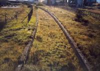 Ardrossan North from the overbridge looking to Montgomerie Pier. The trackbed to the right betrays that the Shell refinery sidings have just been lifted.<br><br>[Ewan Crawford //1987]