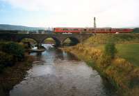 Southbound train crossing the viaduct north of Dalry station. View looks west.<br><br>[Ewan Crawford //1987]