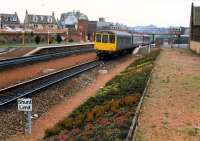 Hybrid DMU heads north from Larbert past the old station building.<br><br>[Ewan Crawford //1988]