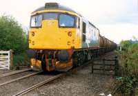 26 with a Molasses train crosses the level crossing at Cambus Junction.<br><br>[Ewan Crawford //1988]