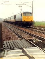 Glasgow train approaches Cove level crossing.<br><br>[Ewan Crawford //1988]