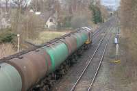 Oil train heading north from Dumfries behind a class 60 in April 2006 passing the abandoned junction for the former Stranraer line.<br><br>[John Furnevel 17/04/2006]