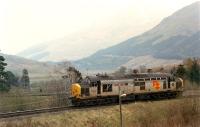 37 403 approaching Crianlarich Junction. It is on the Crianlarich Lower Junction - Crianlarich Junction section heading south, immediately behind is the Fort William line and distant is Crianlarich Lower with a timber train it has just left.<br><br>[Ewan Crawford //1990]