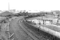 Looking northwest from Rome Street towards Dentonholme along the closed goods line in 1989. The damaged  bridge over the River Caldew is visible just beyond the far corner of the abandoned works yard. [See image 5732]. (The remains of the structure were finally removed in 2008.) <br><br>[John Furnevel 18/05/1989]