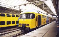 NS double deck commuter trains stand side by side at the platforms of Amsterdam Central station on 5 December 1997.<br><br>[John Furnevel 05/12/1997]