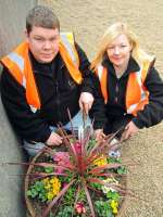 In-Work Ltd members David Steele, from Greenock, and Janette McClumpha, from Port Glasgow, with one of the colourful new planters at Cardonald station [see news item].<br><br>[ScotRail 15/03/2012]