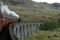 Heading east on Glenfinnan Viaduct. There is a surprising lack of railway paparazzi on the hillside.<br><br>[Ewan Crawford 28/05/2006]