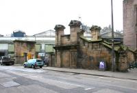 Entrance to Waverley station from Calton Road in July 2006. At one time a choice existed at the top of the steps between either a right turn onto the footbridge leading into the station itself, or straight ahead for the elevated walkway across to Jeffrey Street, the supporting stone pier and part of the framework of which can still be seen here. The gated compound was once used by the Royal Mail. [See image 44229] <br><br>[John Furnevel 30/07/2006]