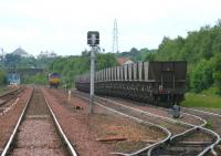 View west from Halbeath level crossing in June 2006 with a locomotive in the process of running round a train of empties in Halbeath sidings. The east end of Queen Margaret station can be seen through the bridge on the left.  <br><br>[John Furnevel 13/06/2006]