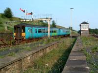 Leeds bound train passes the disused bay platform at the east end of Hellifield station.<br><br>[Ewan Crawford 03/06/2006]
