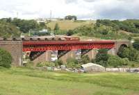<h4><a href='/locations/J/Jamestown_Viaduct_Inverkeithing'>Jamestown Viaduct [Inverkeithing]</a></h4><p><small><a href='/companies/F/Forth_Bridge_Railway'>Forth Bridge Railway</a></small></p><p>Coal train running onto Jamestown Viaduct on the approach to Inverkeithing in June 2006. In the background is the M90 Motorway and cars parked in the <I>Ferry Toll Park and Ride</I> facility can be seen below the viaduct. On the hill above stands part of the former MoD Pitreavie Maritime HQ (the main underground facility having been closed down and sealed in 1995.)    13/14</p><p>20/06/2006<br><small><a href='/contributors/John_Furnevel'>John Furnevel</a></small></p>