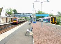 A Glasgow Queen Street service about to depart from Dunblane platform 1 in June 2005, as passengers disembark from a train which has just arrived at platform 3 from Newcraighall.<br><br>[John Furnevel 22/06/2005]